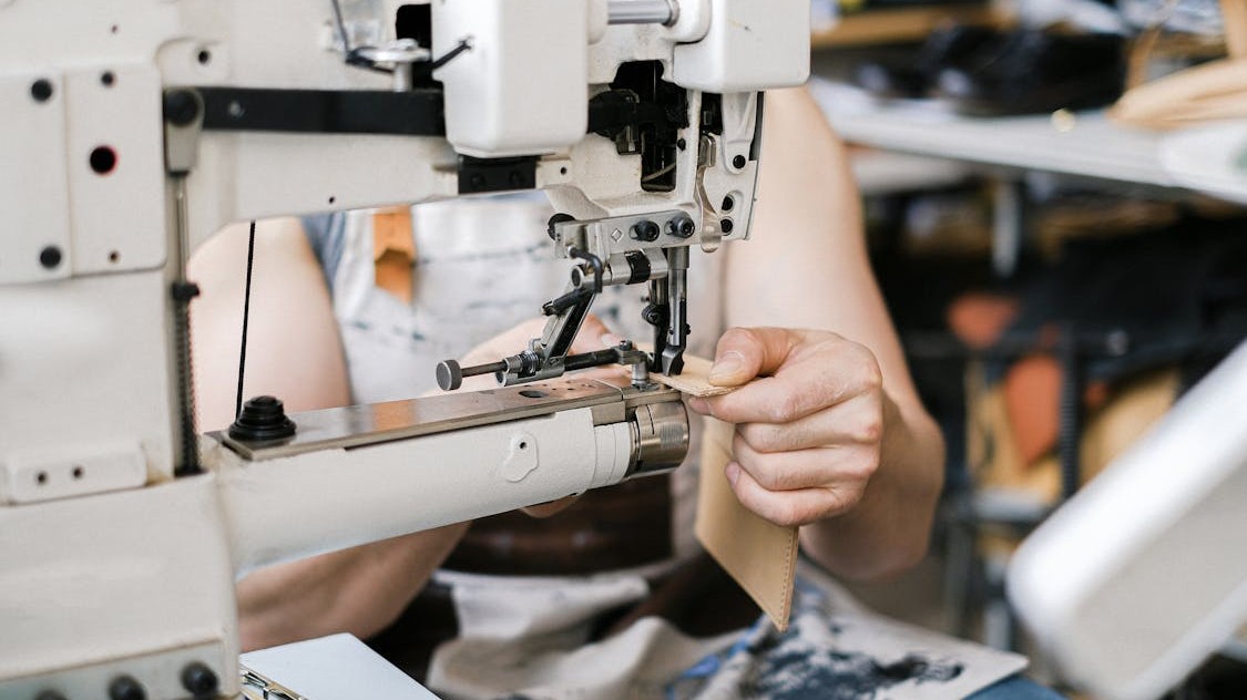 Professional seamstress taking measurements for clothing alterations